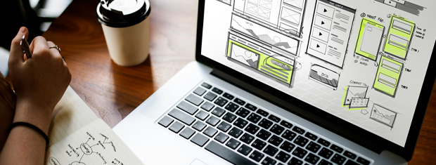 Designer planning out AODA compliant layout on a laptop